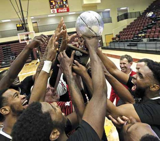 EMCC’s men’s basketball team hoists the MACCC state championship trophy after defeating Northeast in the finals.